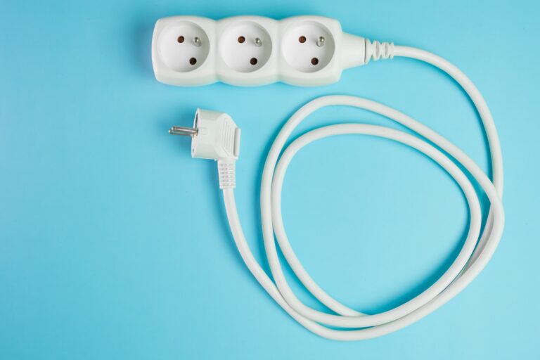 Electric extension cord on the blue background